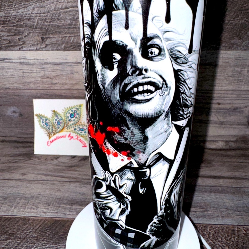 Vibrant black and white with red 20oz stainless steel  beetlejuice tumbler.